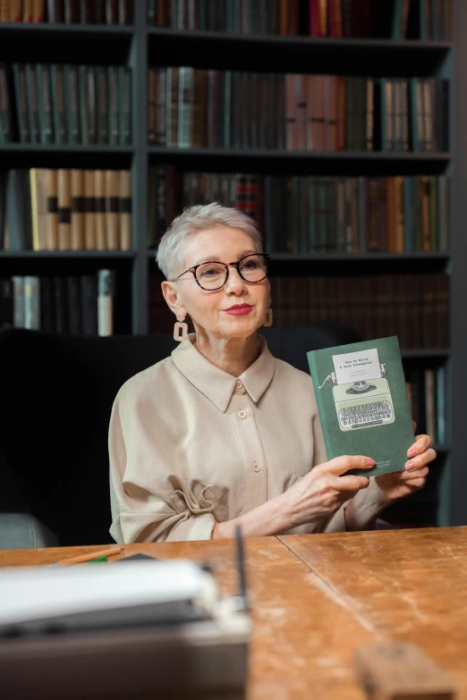 a woman sitting at a table holding a book, gray haired, androgynous person, 2019 trending photo, premium quality