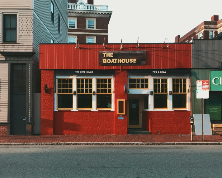 a red building sitting on the side of a road, an illustration of a bar/lounge, boat, clean photo, thalassophobia