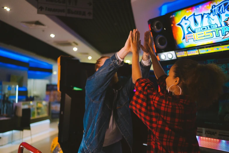a group of people playing a video game, an album cover, pexels contest winner, dancefloor kismet, arcade machine, showing victory, southern cross