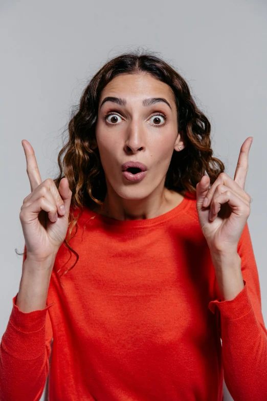 a woman making a funny face with her fingers, pexels, antipodeans, on clear background, h3h3, surprised, two