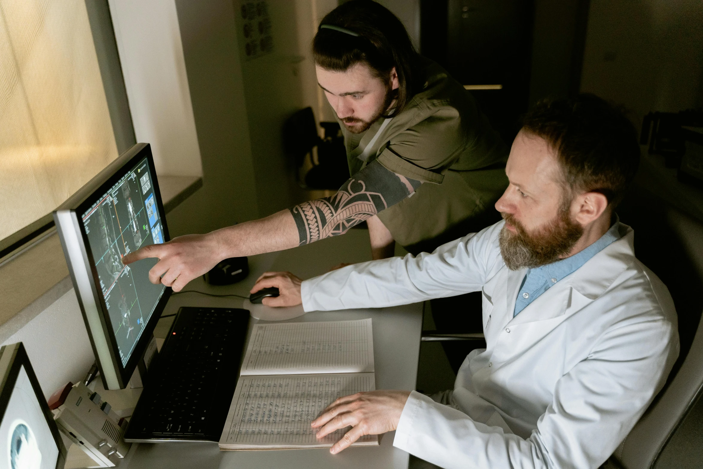 two men in lab coats looking at a computer screen, by Adriaen Hanneman, pexels, gakkin and ernst haeckel, grey, brown, mid - shot