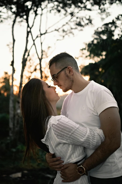 a man and a woman standing next to each other, pexels contest winner, romanticism, trees in background, making out, late afternoon, attractive man