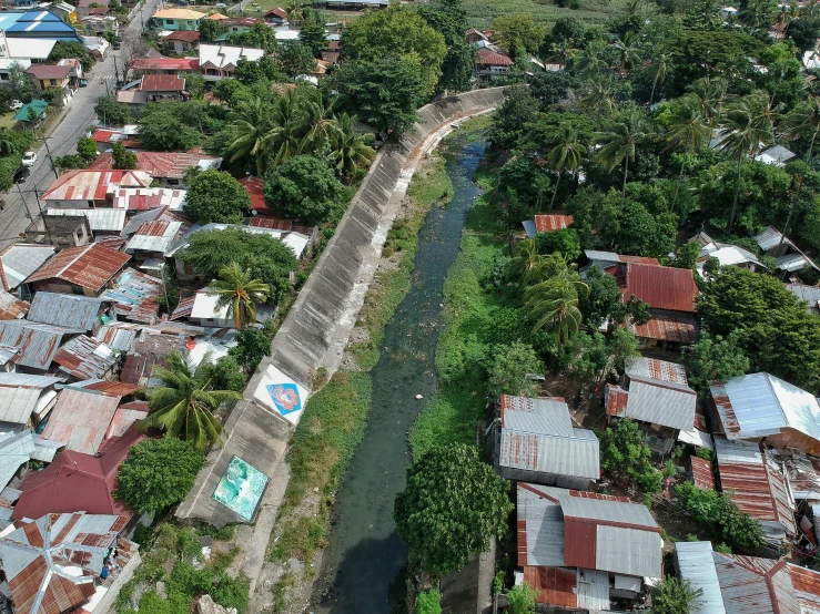 an aerial view of a city with a river running through it, an album cover, pexels contest winner, hurufiyya, philippines, in a suburb, thumbnail, canal