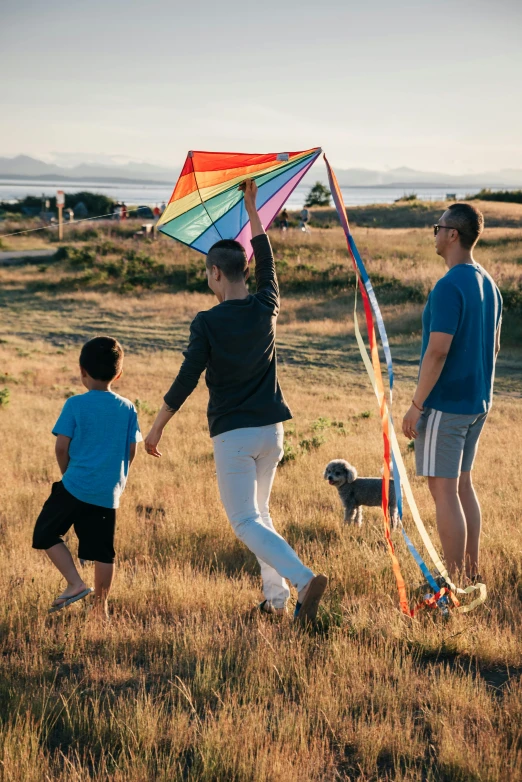 a family flying a kite in a field, seattle, lgbtq, on the ocean, profile image