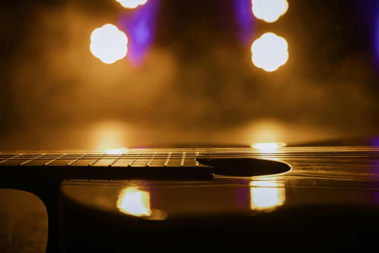 a guitar sitting on top of a wooden table, by Niko Henrichon, pexels contest winner, light and space, smokey lights, party lights, 15081959 21121991 01012000 4k, a round minimalist behind