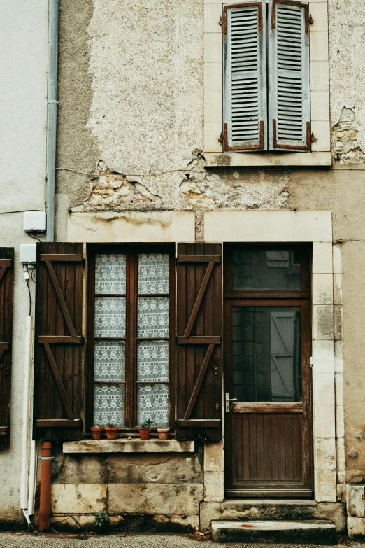 a red fire hydrant sitting in front of a building, a photo, pexels contest winner, renaissance, french door window, brown and cream color scheme, shutters, tiny house