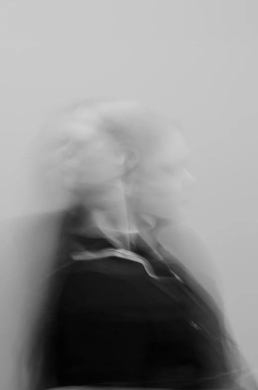 a blurry photo of a person holding a cell phone, a black and white photo, inspired by Anna Füssli, conceptual art, mist rising from head, both faces visible, motion blured movement, julia hetta