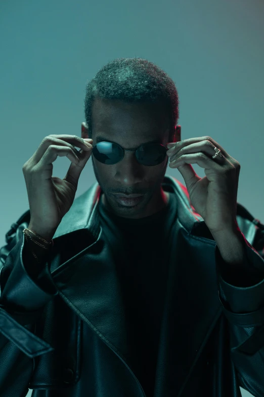 a man in a leather jacket and sunglasses, an album cover, inspired by Terrell James, trending on pexels, bauhaus, a teen black cyborg, movie still from the matrix, playboi carti portrait, tall thin