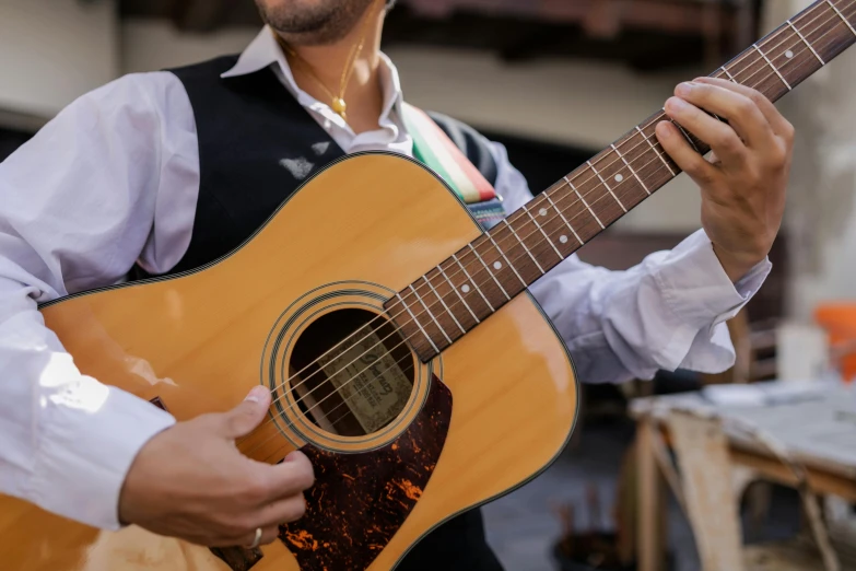 a close up of a person holding a guitar, inspired by Girolamo Muziano, pexels contest winner, renaissance, al fresco, lightly dressed, australian, on a stage