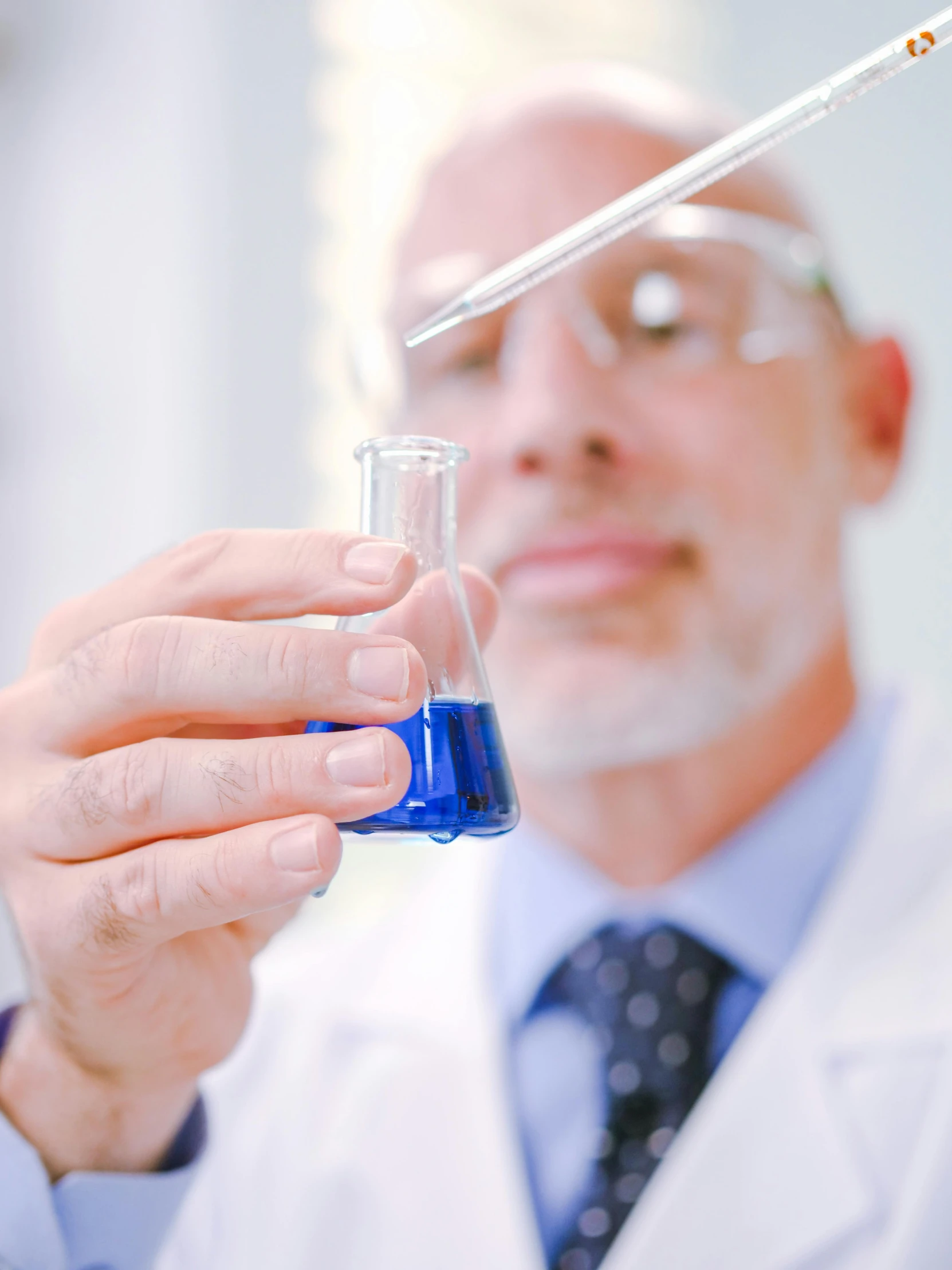 a man in a lab coat holding a test tube, trending on reddit, wearing blue robe, hydration, thumbnail, high-quality photo