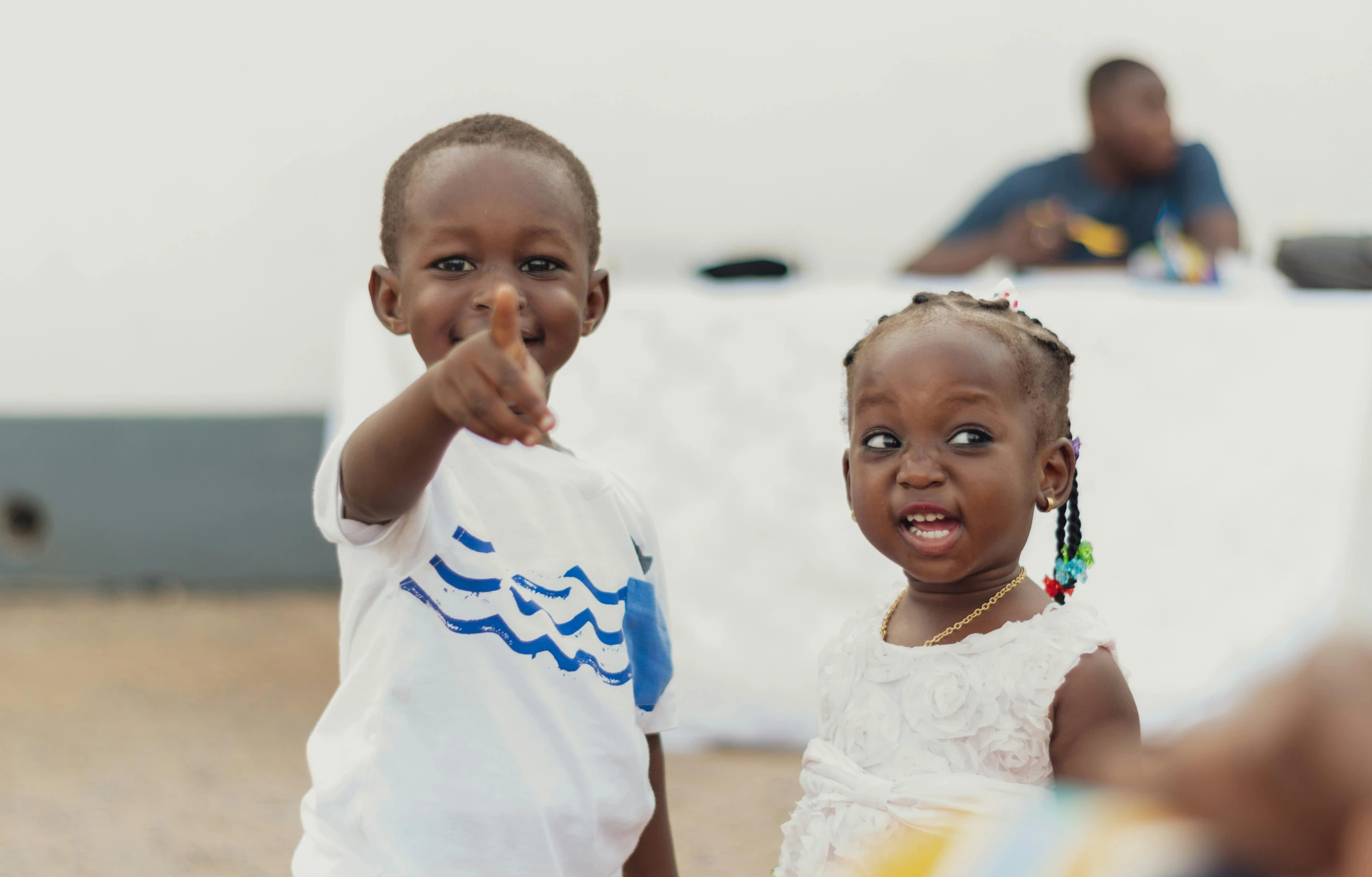 a couple of young children standing next to each other, pexels contest winner, happening, emmanuel shiru, waving at the camera, avatar image, baptism