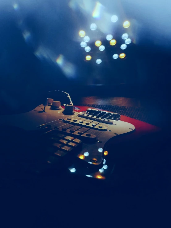 a close up of a keyboard with lights in the background, an album cover, unsplash, happening, fender stratocaster, on an empty stage from above, digitally enhanced, instagram picture