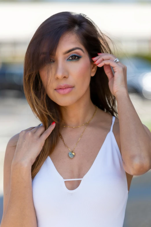 a woman in a white tank top posing for a picture, by Robbie Trevino, gemstone necklace, kyza saleem, official store photo, coast