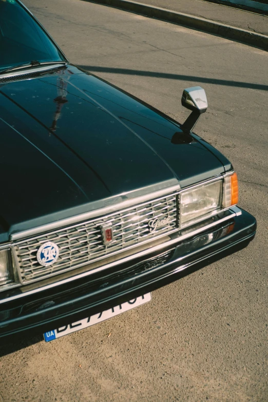 a black car parked on the side of the road, pexels contest winner, photorealism, toyota cresta, close up 1 9 9 0, shiny silver, brown