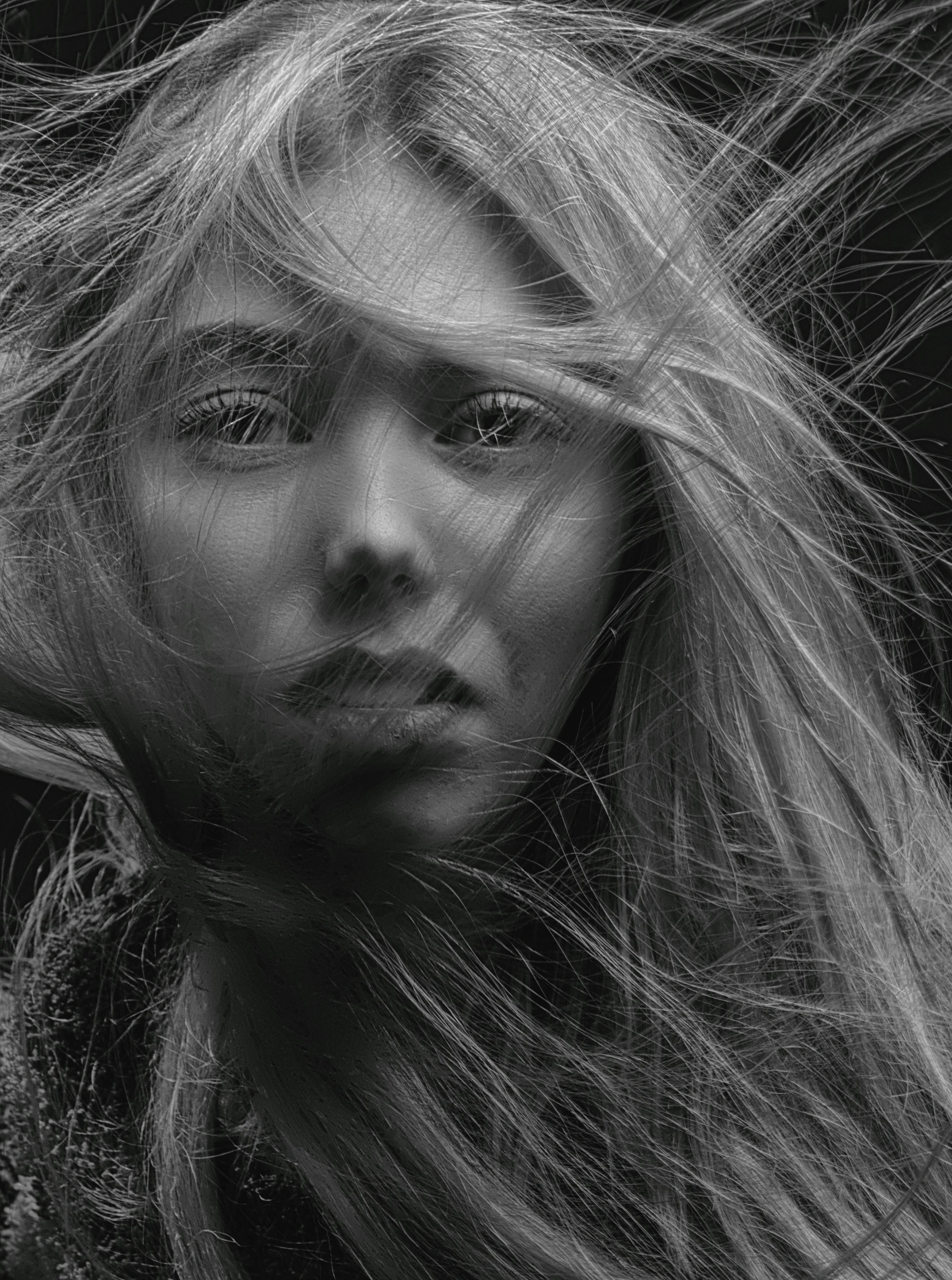 a black and white photo of a woman with long hair, by andrei riabovitchev, pexels contest winner, digital art, messy blond hair, closeup!!!!!!, beautiful young wind spirit, cinematic. by leng jun