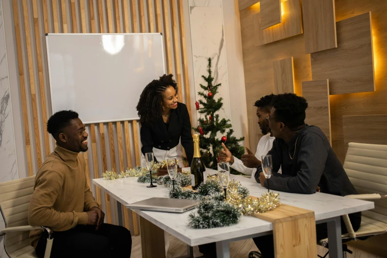 a group of people sitting around a table, a photo, holiday season, black people, profile image, decoration around the room