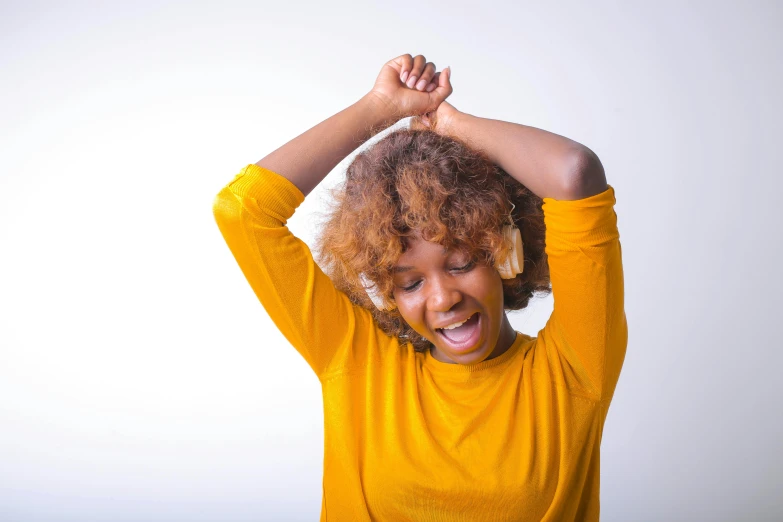 a woman in a yellow shirt is holding her hair in the air, trending on pexels, hurufiyya, sleepy, afro tech, scratching head, ad image