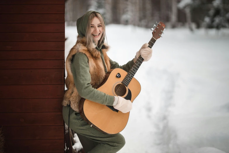 a woman holding a guitar in the snow, inspired by Louisa Matthíasdóttir, pexels contest winner, avatar image, russian clothes, cottagecore hippie, solid background