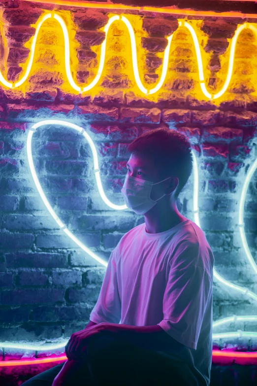 a man sitting in front of a neon sign, pexels contest winner, portrait of 1 5 - year - old boy, wearing a mask, neon heart reactor, asian man