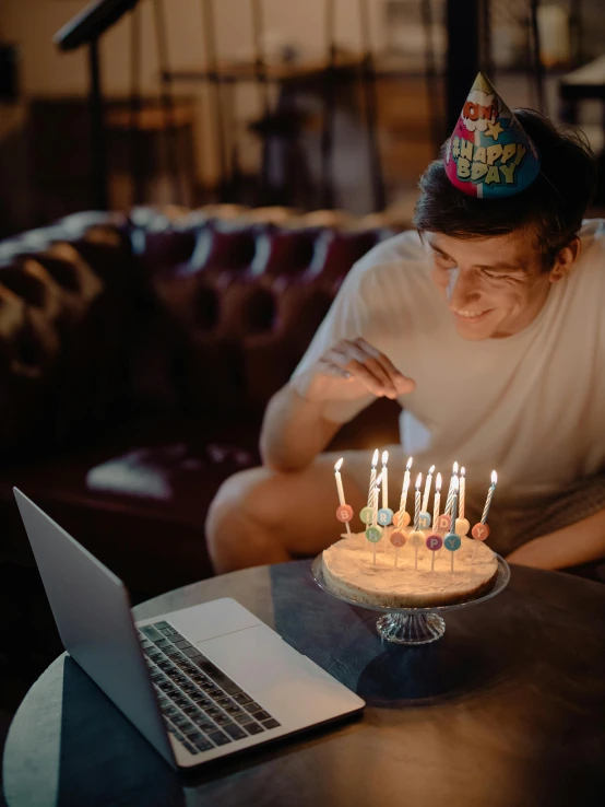 a man blowing out candles on a birthday cake, a colorized photo, pexels contest winner, happening, with a laptop on his lap, trending on vsco, ( ( theatrical ) ), gif