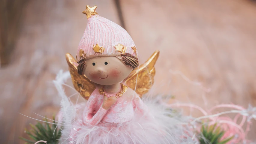 a close up of a doll on a table, by Marie Angel, pexels contest winner, arabesque, angel halo, pink and gold, soft and fluffy, festive