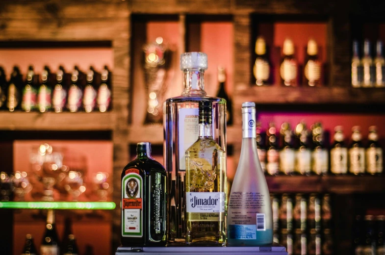 bottles of alcohol sitting on top of a counter, by Niko Henrichon, pexels contest winner, renaissance, neon standup bar, profile image, new mexico, basic background