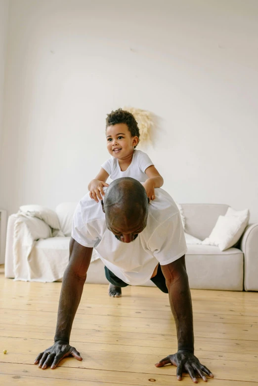 a man and a child doing a handstand in a living room, profile image, brown, lightweight, toddler