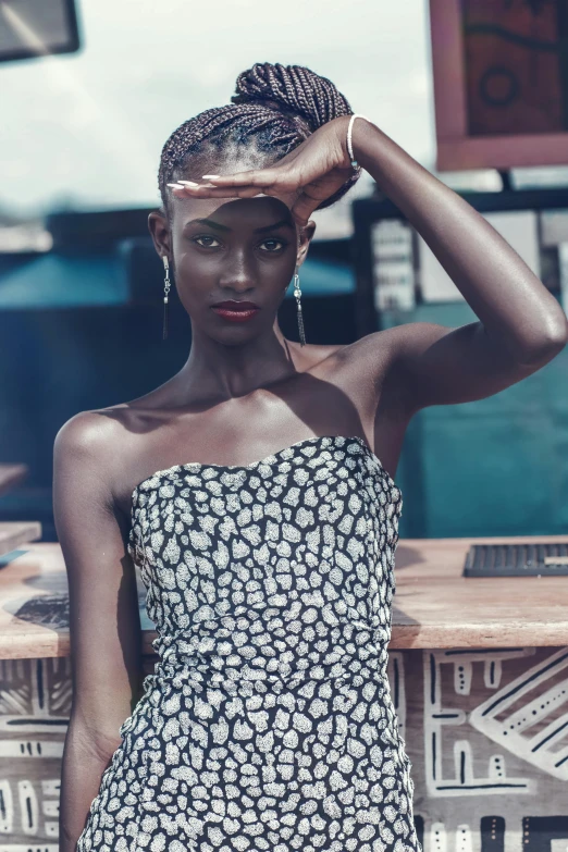 a woman in a black and white dress posing for a picture, trending on pexels, afrofuturism, adut akech, she has olive brown skin, tube-top dress, delicate patterned