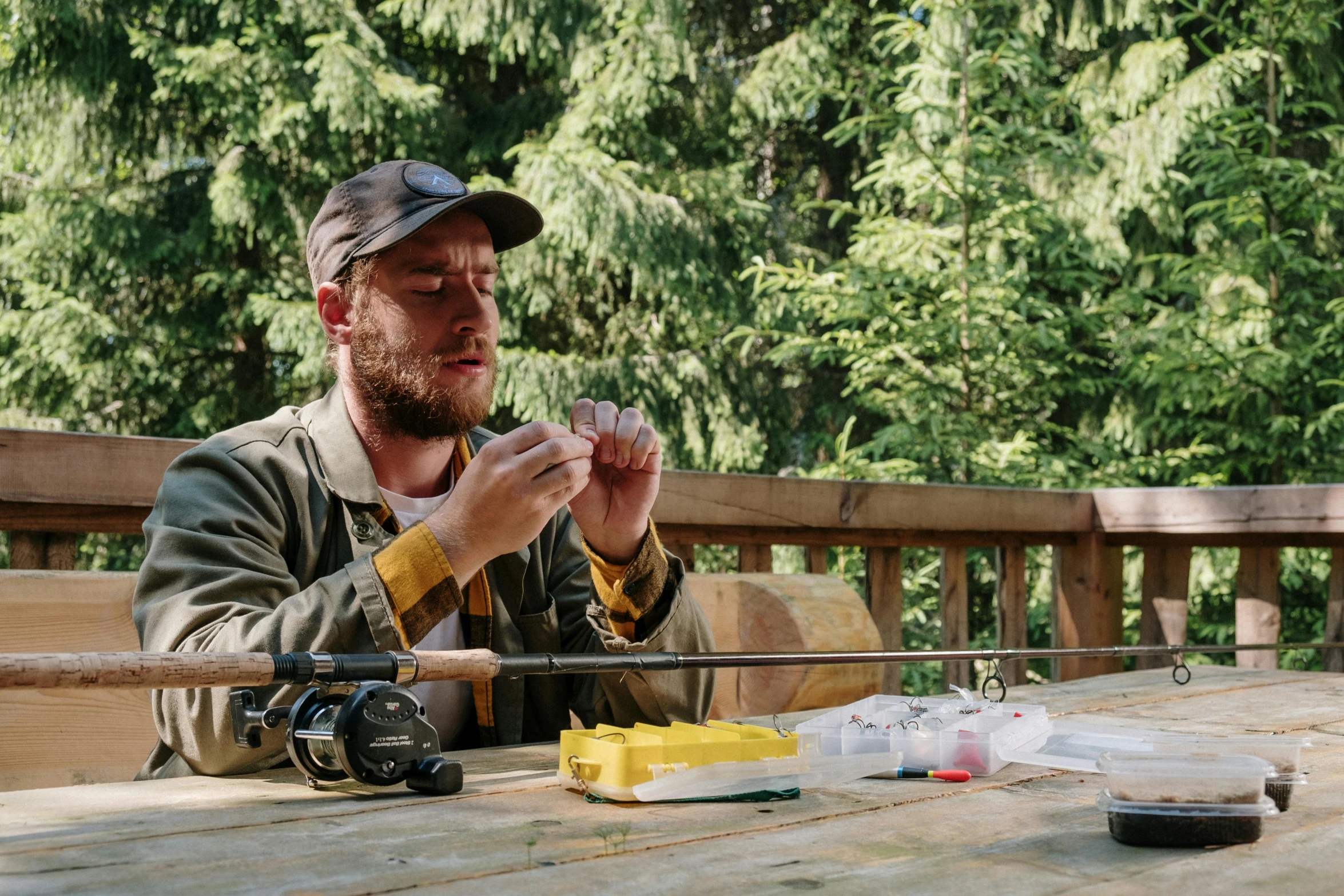 a man sitting at a picnic table eating food, process art, fishing, tv still, ash thorp, food. craft and adventure