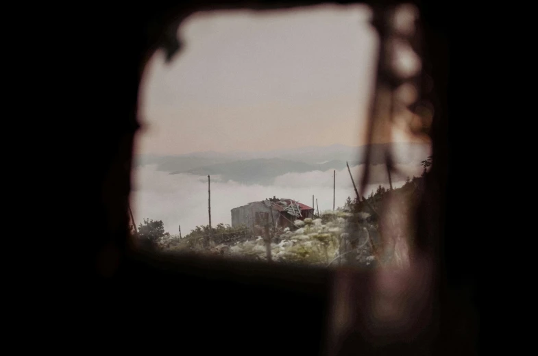 a view of a building through a window, by Nathalie Rattner, pexels contest winner, abandoned war torn village, view from a news truck, hazy, mina petrovic