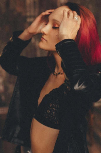a woman with red hair wearing a black jacket, inspired by Elsa Bleda, trending on pexels, renaissance, bralette, leathery, indoor picture, red and black