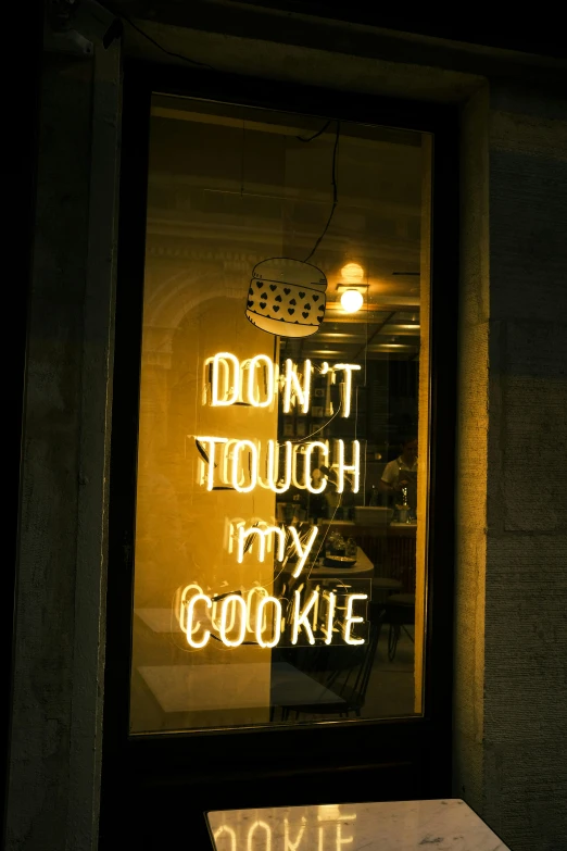 a sign in a window that says don't touch my cookie, by Doug Ohlson, trending on pexels, cool lights, dour