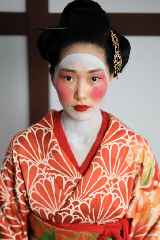 a woman in a kimono is posing for a picture, a portrait, inspired by Uemura Shōen, trending on unsplash, white facepaint, red faced, looking serious, 2010s