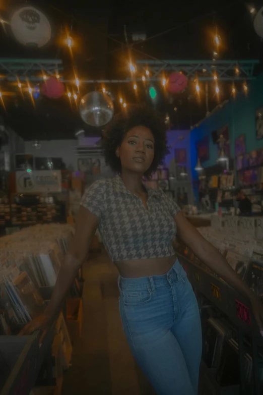 a woman standing in the middle of a store, an album cover, trending on unsplash, funk art, super cute funky black girl, still from a music video, holographic undertones, shot in wide angle