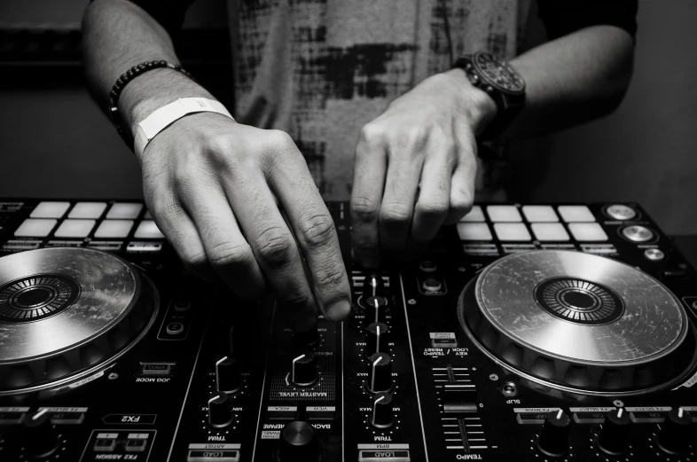 a close up of a person using a dj controller, by Robbie Trevino, avatar image, black and white, 2 arms, uploaded