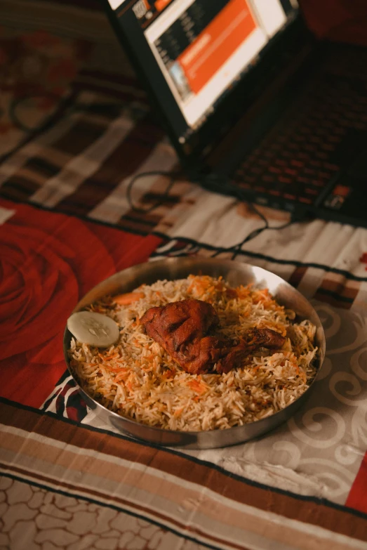 a plate of food on a table with a laptop in the background, by Riza Abbasi, hurufiyya, high-quality photo, bird view, rice, in night