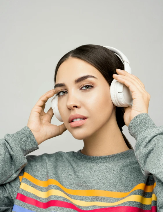 a young woman listening to music with headphones, by Adam Marczyński, happening, wearing a white sweater, background image, multiple stories, high quality product image”