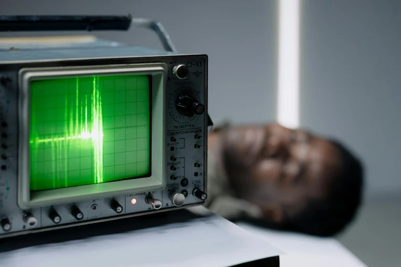 a man laying on a bed next to a radio, unsplash, holography, in a laboratory, obunga, oscilloscope, still image from tv series