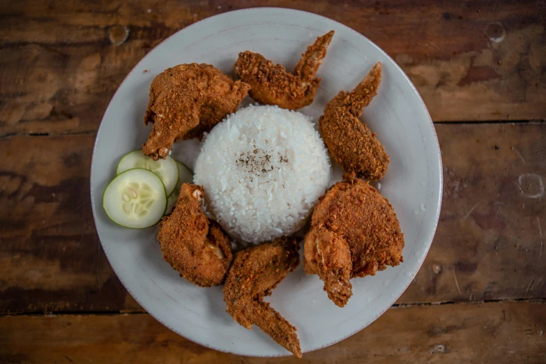 a white plate topped with fried chicken and rice, pexels contest winner, hurufiyya, 6 pack, wide high angle view, puerto rico, devil wings