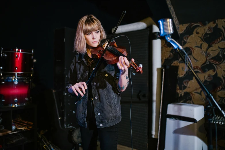 a woman playing a violin in a recording studio, by Nick Fudge, unsplash, with a fringe, performing on stage, lachlan bailey, nina masic