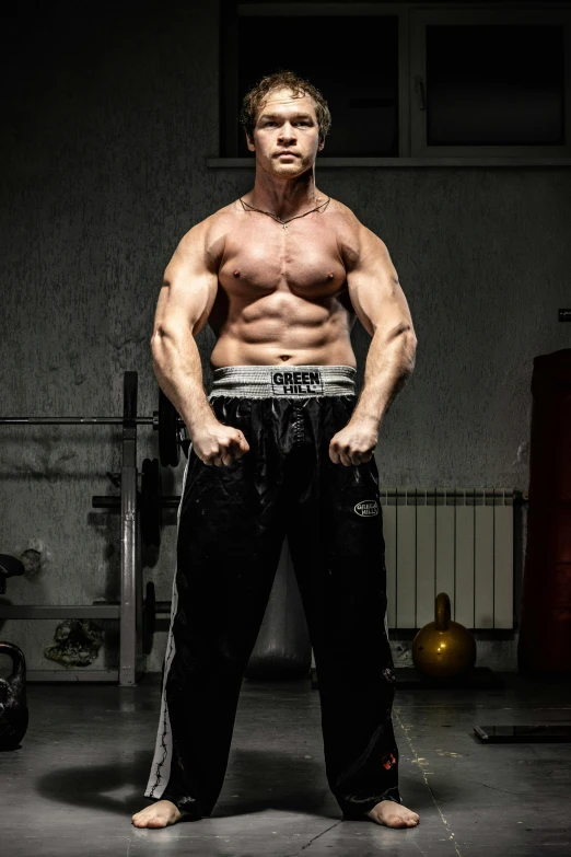 a man posing for a picture in a gym, by Adam Marczyński, happening, half body cropping, posing ready for a fight, hgh, hulking