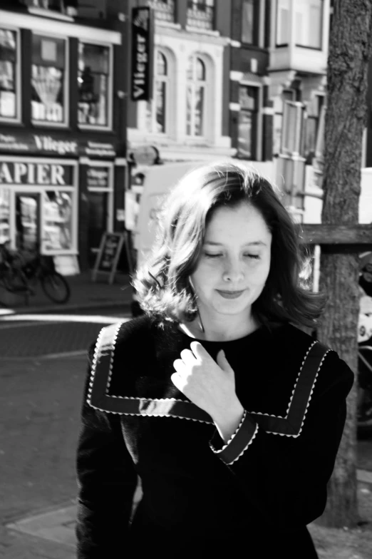 a black and white photo of a woman walking down the street, inspired by Vivian Maier, tumblr, miranda otto as eowyn, utrecht, girl with brown hair, square