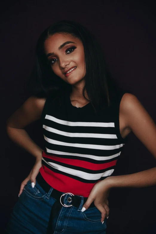 a woman posing with her hands on her hips, a colorized photo, inspired by Glòria Muñoz, trending on pexels, hurufiyya, wearing stripe shirt, black red white clothes, meredit frampton style, headshot profile picture