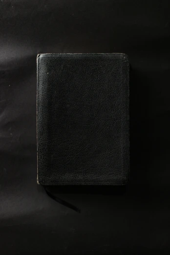 an open bible sitting on top of a black cloth, an album cover, unsplash, paul barson, square, 1907, blank