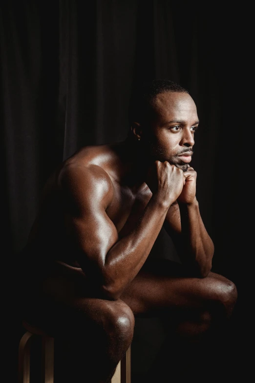 a man sitting on top of a wooden stool, an album cover, inspired by Terrell James, pexels contest winner, hyperrealism, man is with black skin, seducing expression, 30 year old man :: athletic, portrait of muscular