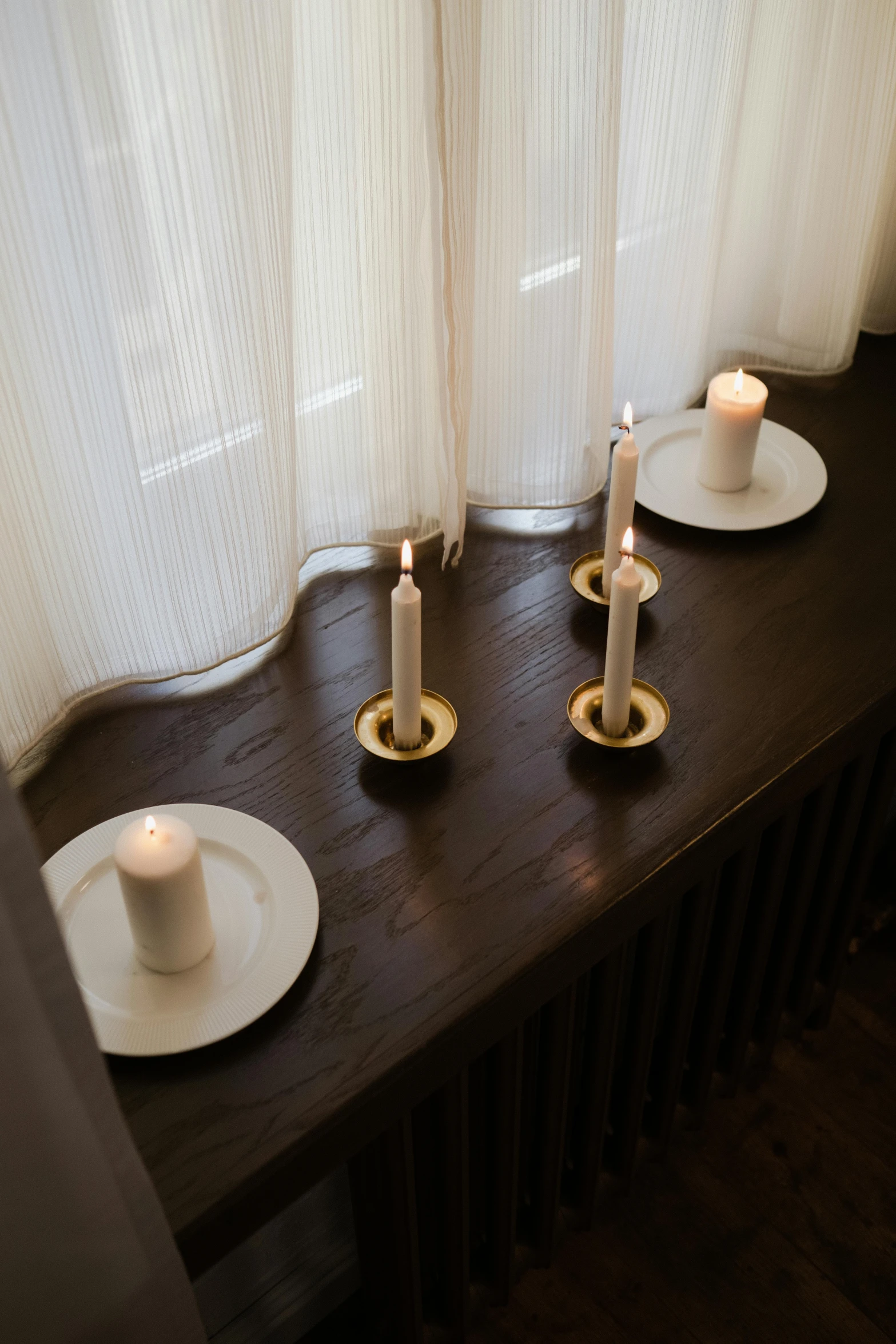 a couple of candles sitting on top of a wooden table, inspired by Einar Hakonarson, renaissance, center parted curtain bangs, porcelain, hammershøi, white and gold color scheme