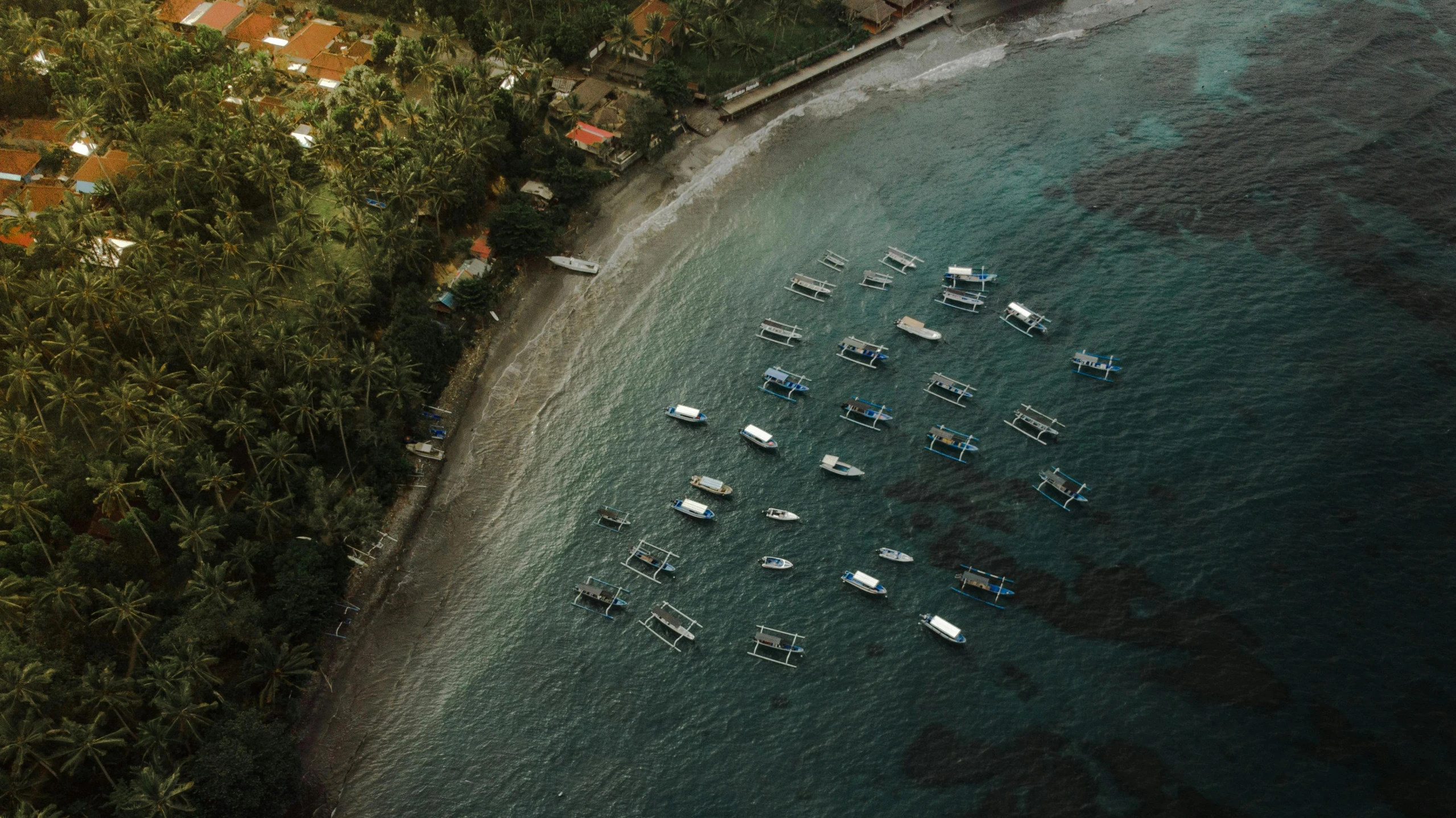 a group of boats floating on top of a body of water, by Carey Morris, pexels contest winner, bali, fan favorite, aerial footage, small port village