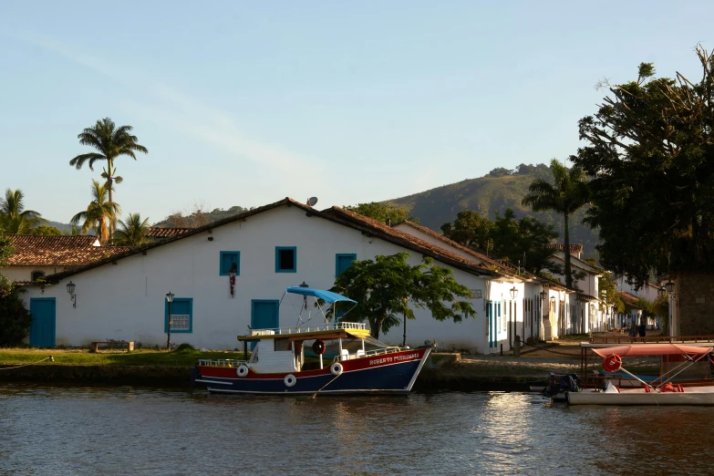 a couple of boats that are in the water, by Ceferí Olivé, house's and shops and buildings, slide show, white, thomas river