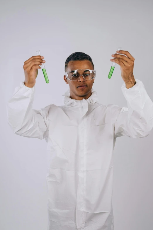 a man in a lab coat holding two test tubes, inspired by Dr. Atl, green shades, streetwear, future inflatable jacket, promo image