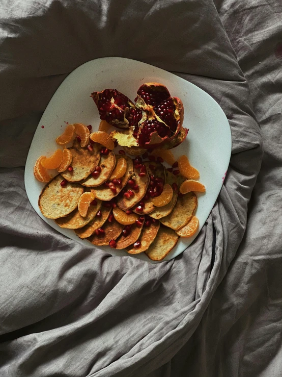a plate of food sitting on top of a bed, by Carey Morris, slices of orange, maroon, jovana rikalo, no cropping